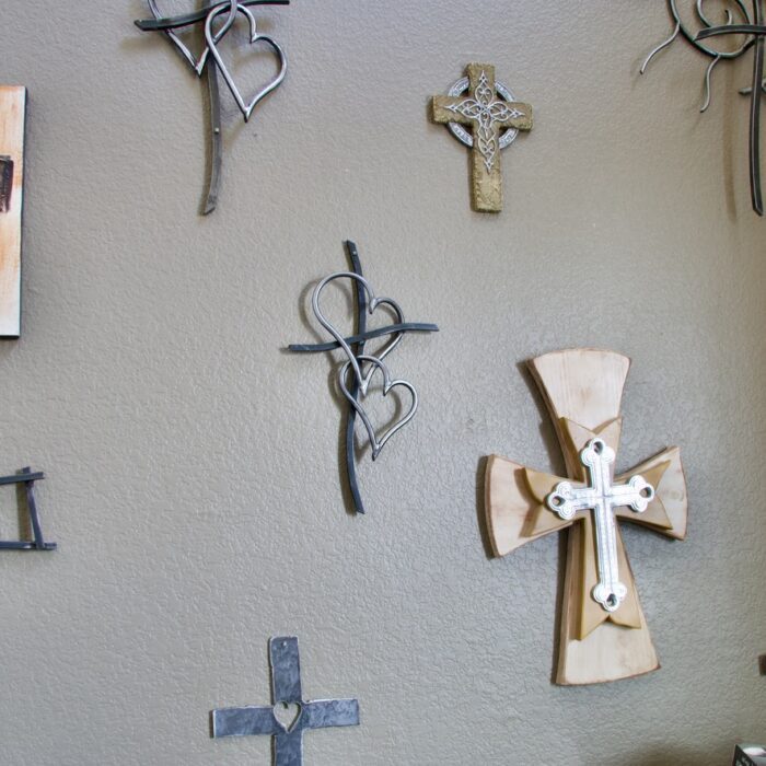 A wall with crosses hanging on it