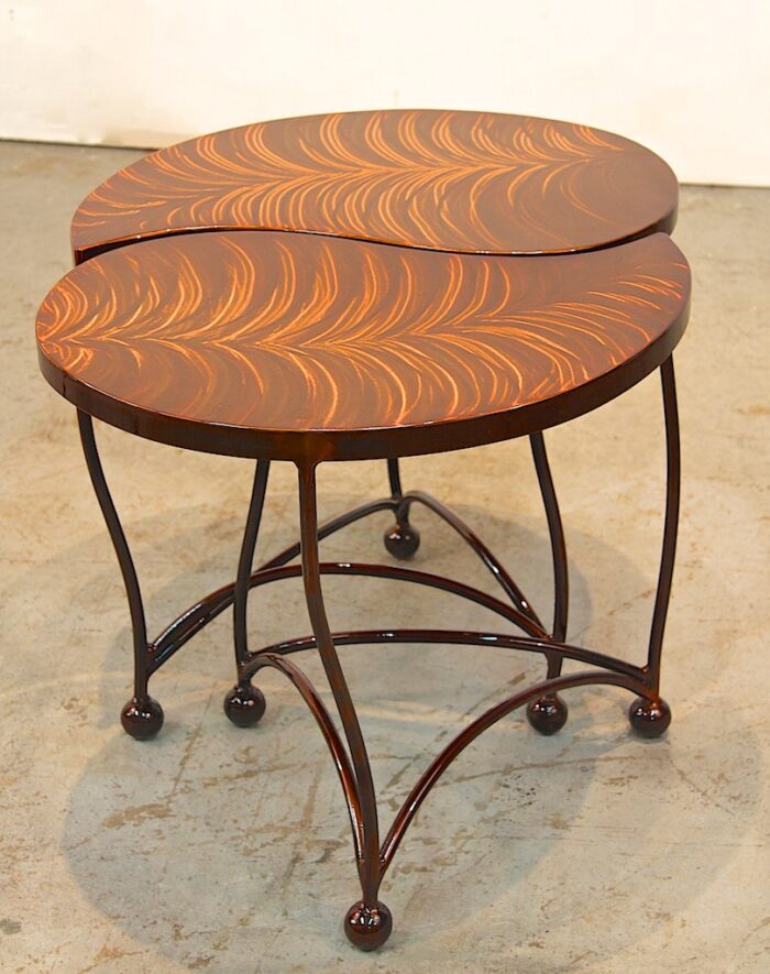 A pair of tables with a leaf design on them.