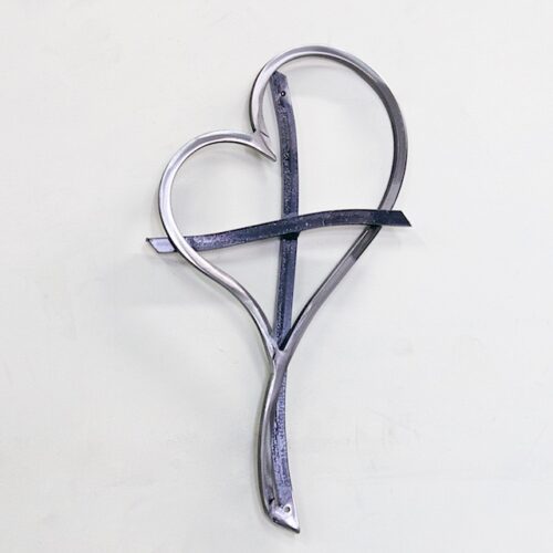 A metal heart with a cross on it.