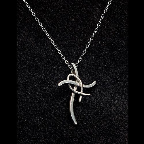 A silver necklace with a cross on it
