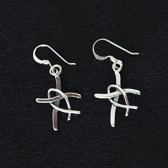 A pair of silver earrings with a cross on them.