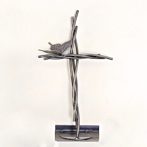 A cross made of metal with a bird on it.