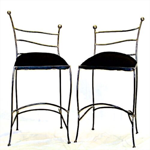 A pair of metal chairs with black seats.