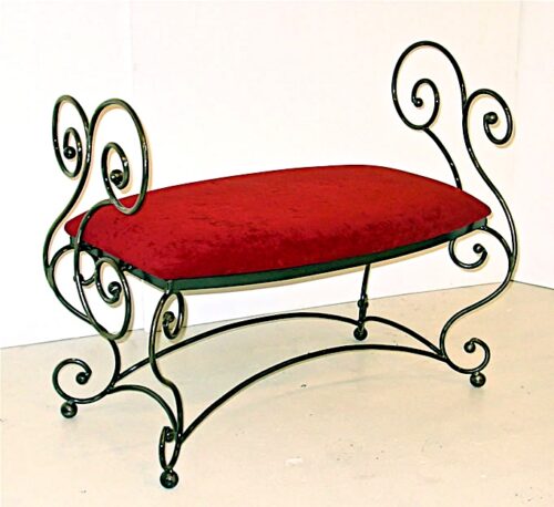 A bench with red seat and black metal frame.