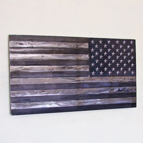 A wooden american flag hanging on the wall.