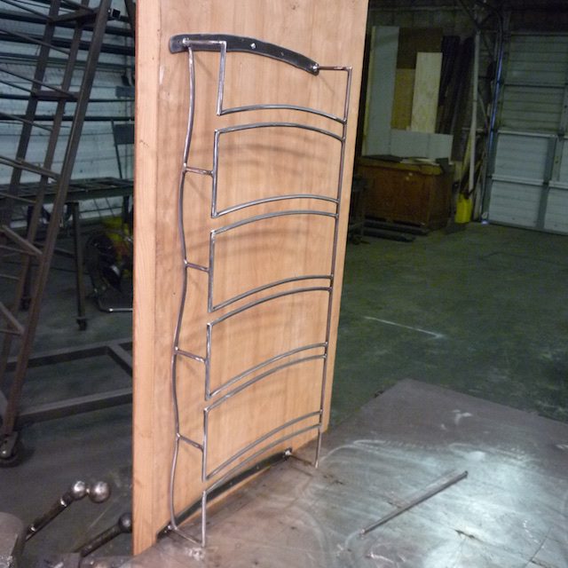 A wooden door with metal bars on the side.