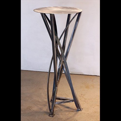 A tall table with metal legs and a white top.