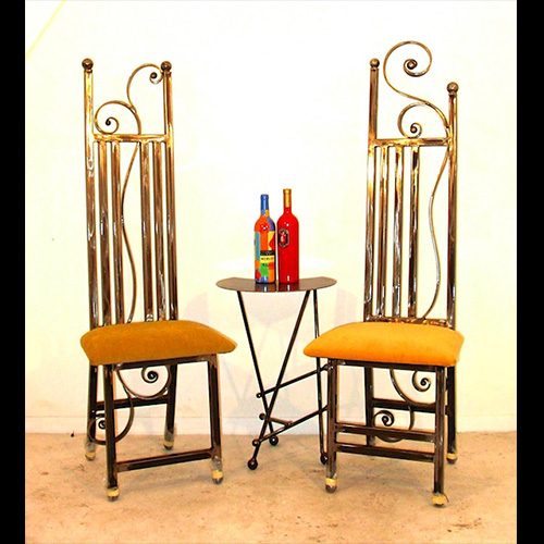 Two chairs and a table with bottles on it