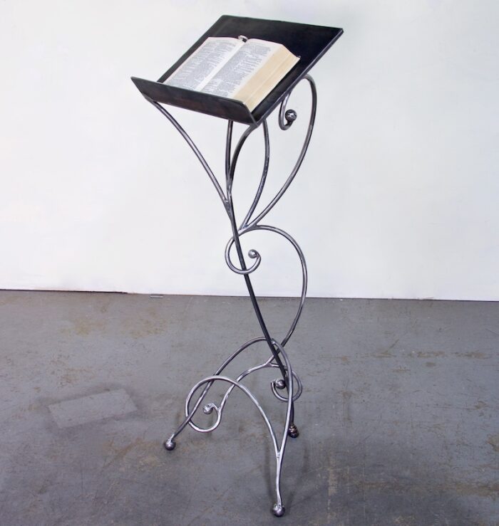 A metal stand with a book on top of it.
