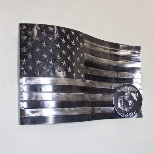 A metal american flag with a coin on it.