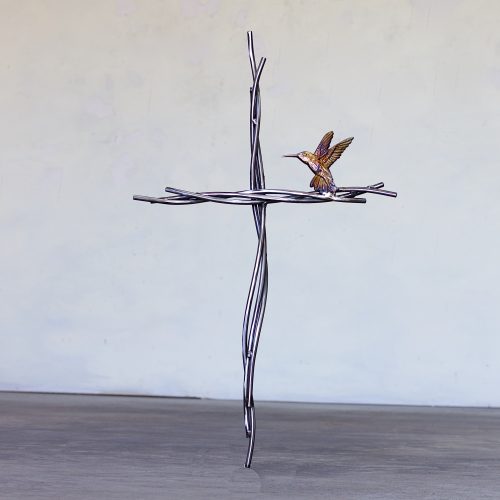 A cross with a bird sitting on it.