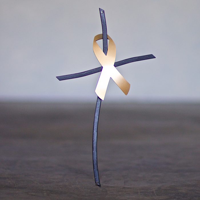 A cross with a ribbon on it.