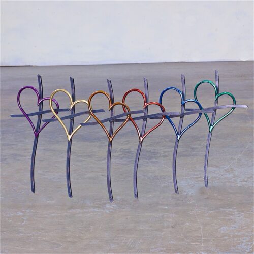 A group of scissors that are in the shape of hearts.