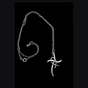 A silver necklace with a cross on it.