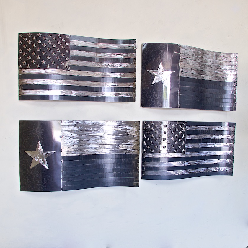 A set of four metal american flags with the star on each flag.
