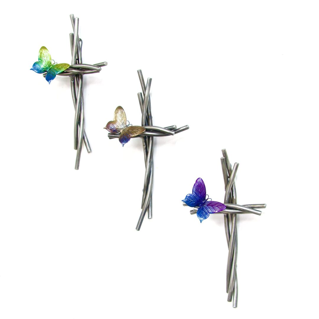 A set of three crosses with butterflies on them.